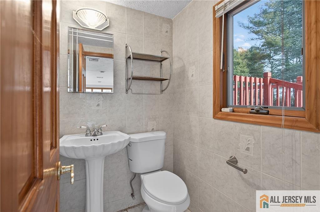 352 Rahway Road Edison, NJ 08820 - Photo 12 of 30 a bathroom with a sink a mirror and a toilet