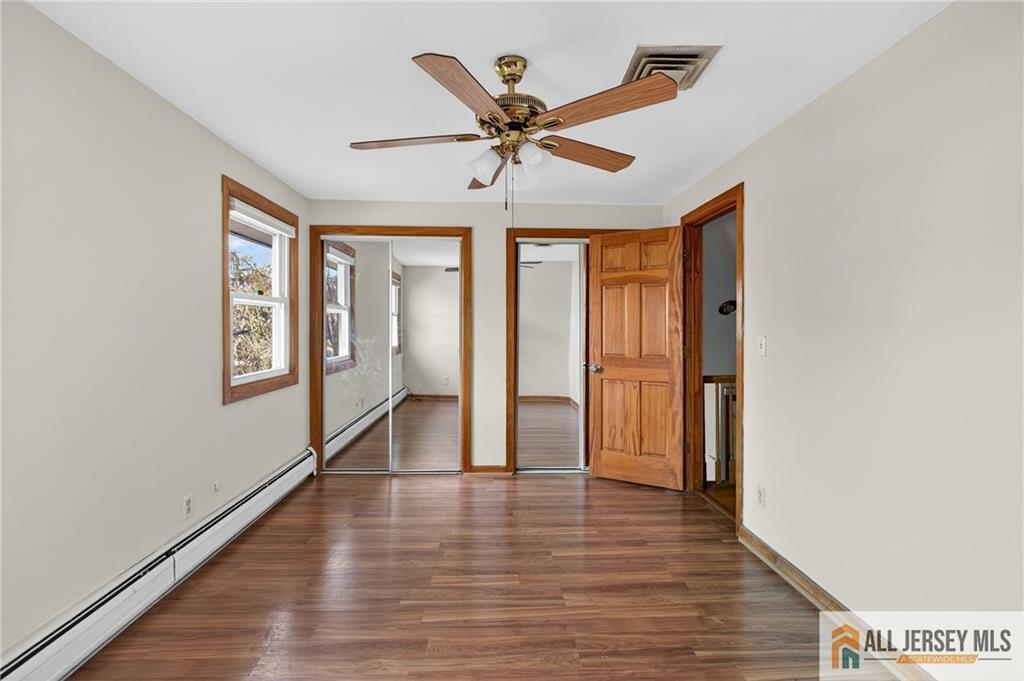 352 Rahway Road Edison, NJ 08820 - Photo 15 of 30 a view of an empty room with window and wooden floor