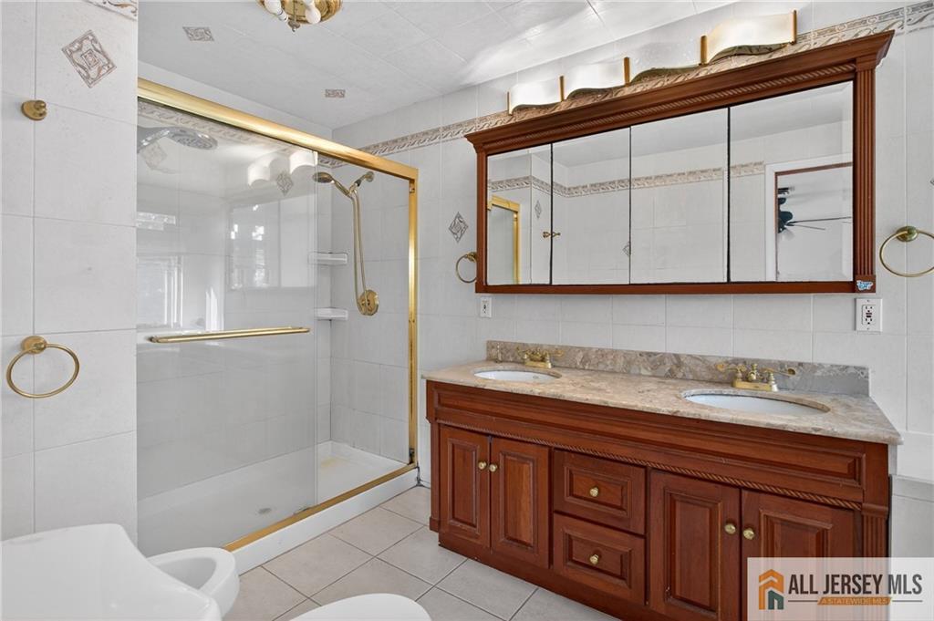 352 Rahway Road Edison, NJ 08820 - Photo 16 of 30 a bathroom with a shower sink and mirror