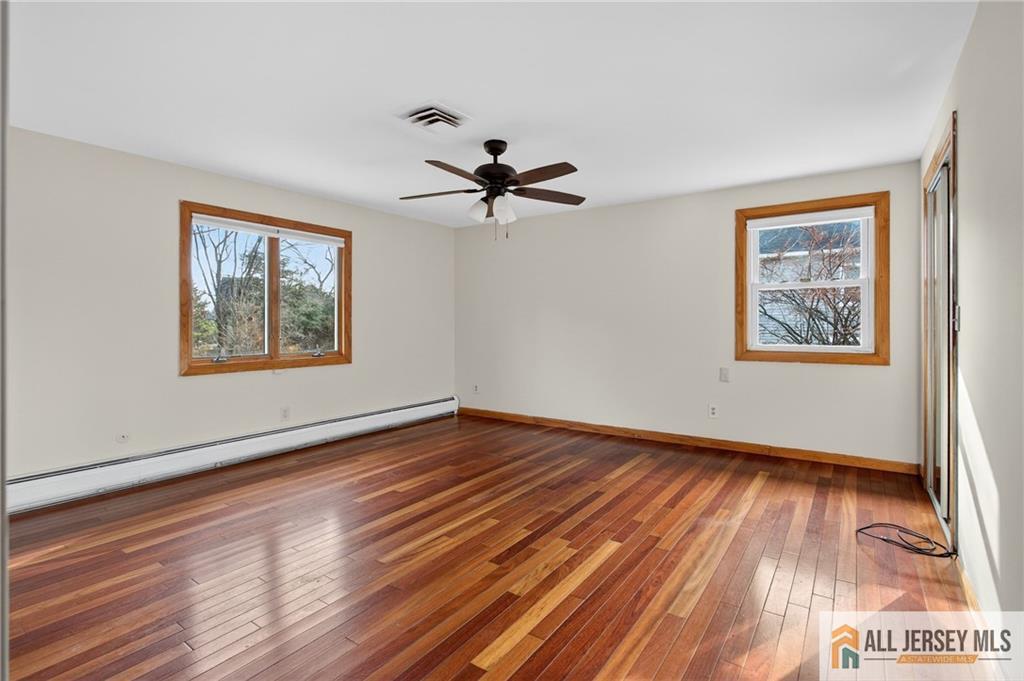 352 Rahway Road Edison, NJ 08820 - Photo 19 of 30 a view of an empty room with wooden floor and a window