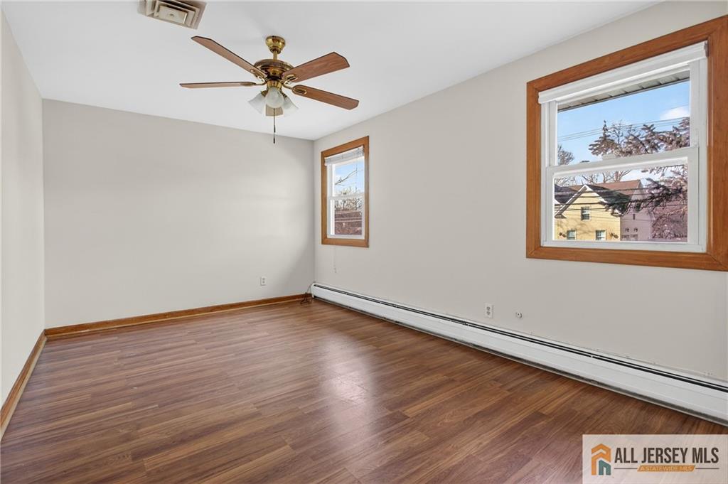 352 Rahway Road Edison, NJ 08820 - Photo 23 of 30 an empty room with wooden floor and ceiling fan