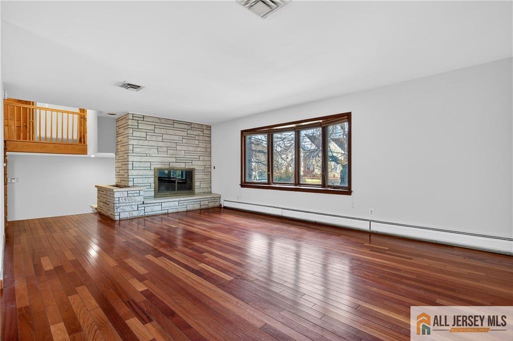 352 Rahway Road Edison, NJ 08820 - Photo 4 of 30 wooden floor fireplace and windows in an empty room