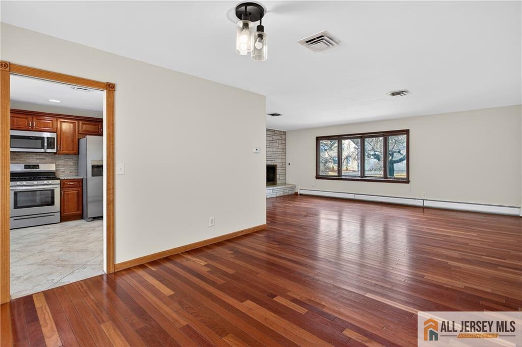 352 Rahway Road Edison, NJ 08820 - Photo 5 of 30 a view of empty room with wooden floor and fan