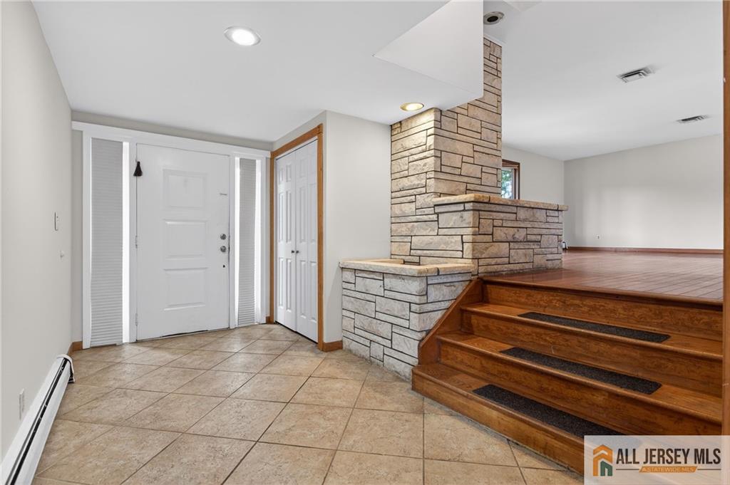 352 Rahway Road Edison, NJ 08820 - Photo 8 of 30 a view of entryway with stairs and a rug