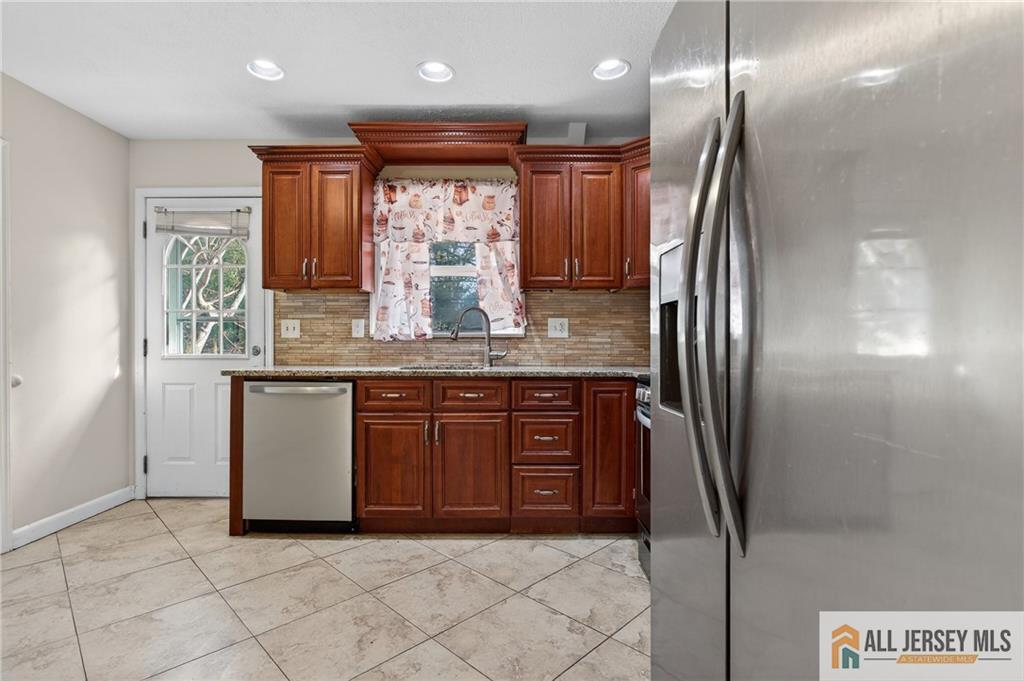 352 Rahway Road Edison, NJ 08820 - Photo 9 of 30 a kitchen with stainless steel appliances granite countertop a refrigerator and a sink