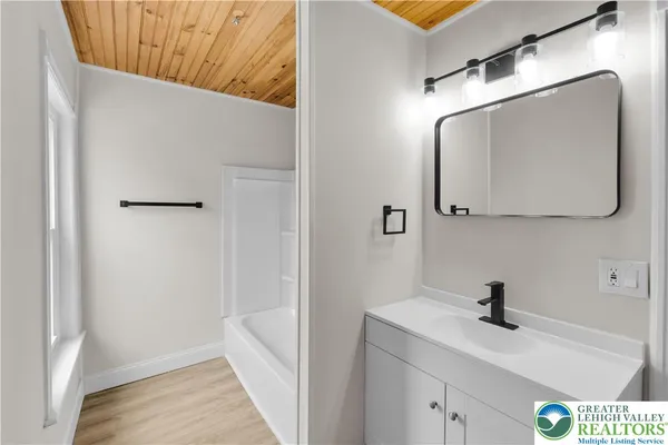 a bathroom with a sink and mirror