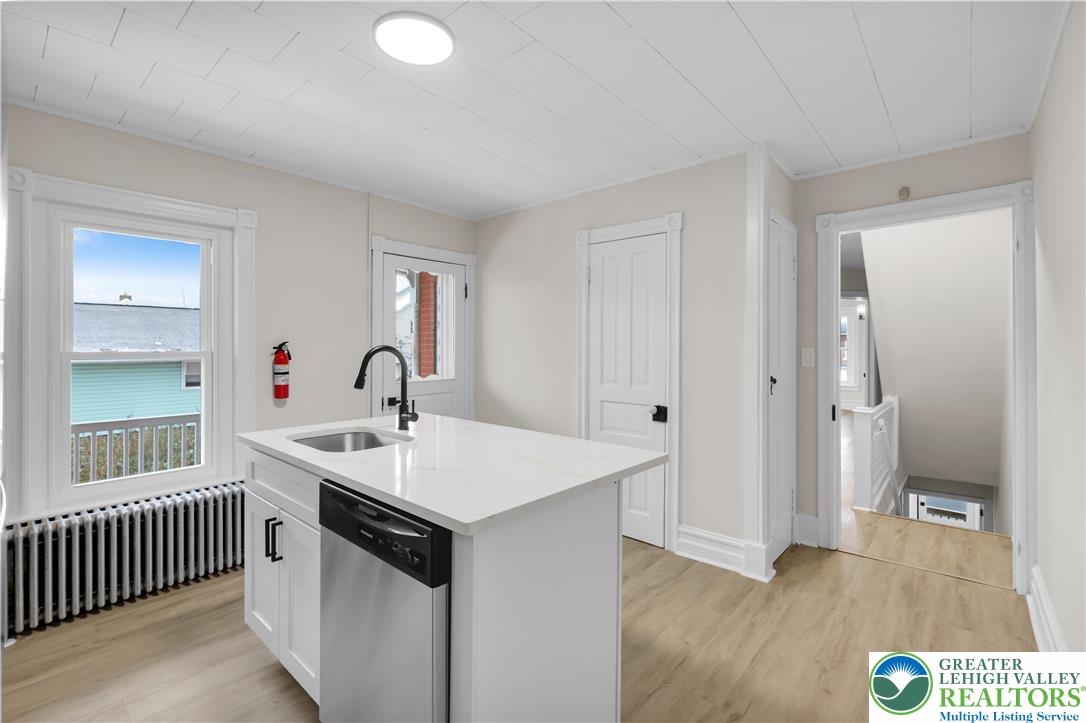 109 North Sixth Street Emmaus, PA 18049 - Photo 14 of 23 a kitchen with a sink and a wooden floor