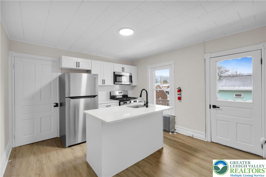 109 North Sixth Street Emmaus, PA 18049 - Photo 15 of 23 a view of a kitchen with refrigerator and wooden floor