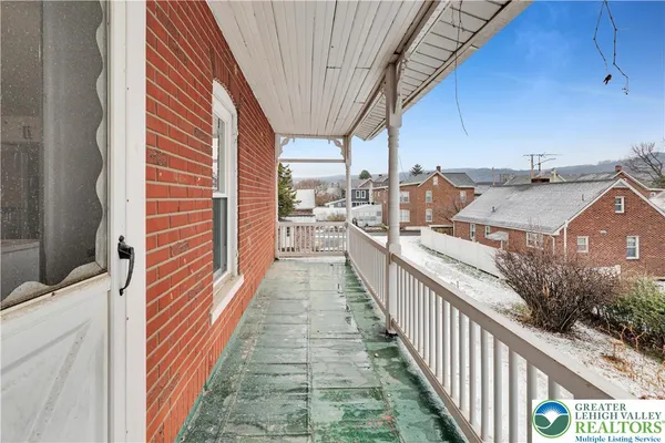 a view of a balcony and car parked