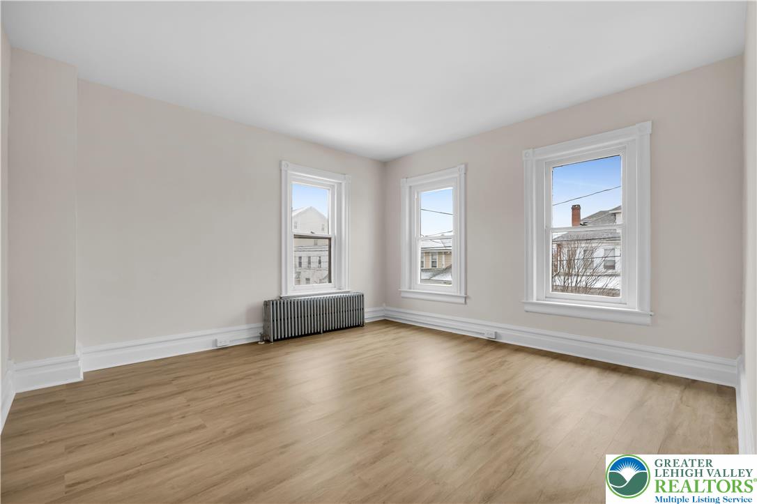 109 North Sixth Street Emmaus, PA 18049 - Photo 6 of 23 an empty room with wooden floor and windows