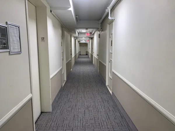 a view of hallway with wooden floor