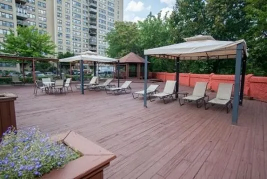 an outdoor space with patio and white umbrellas