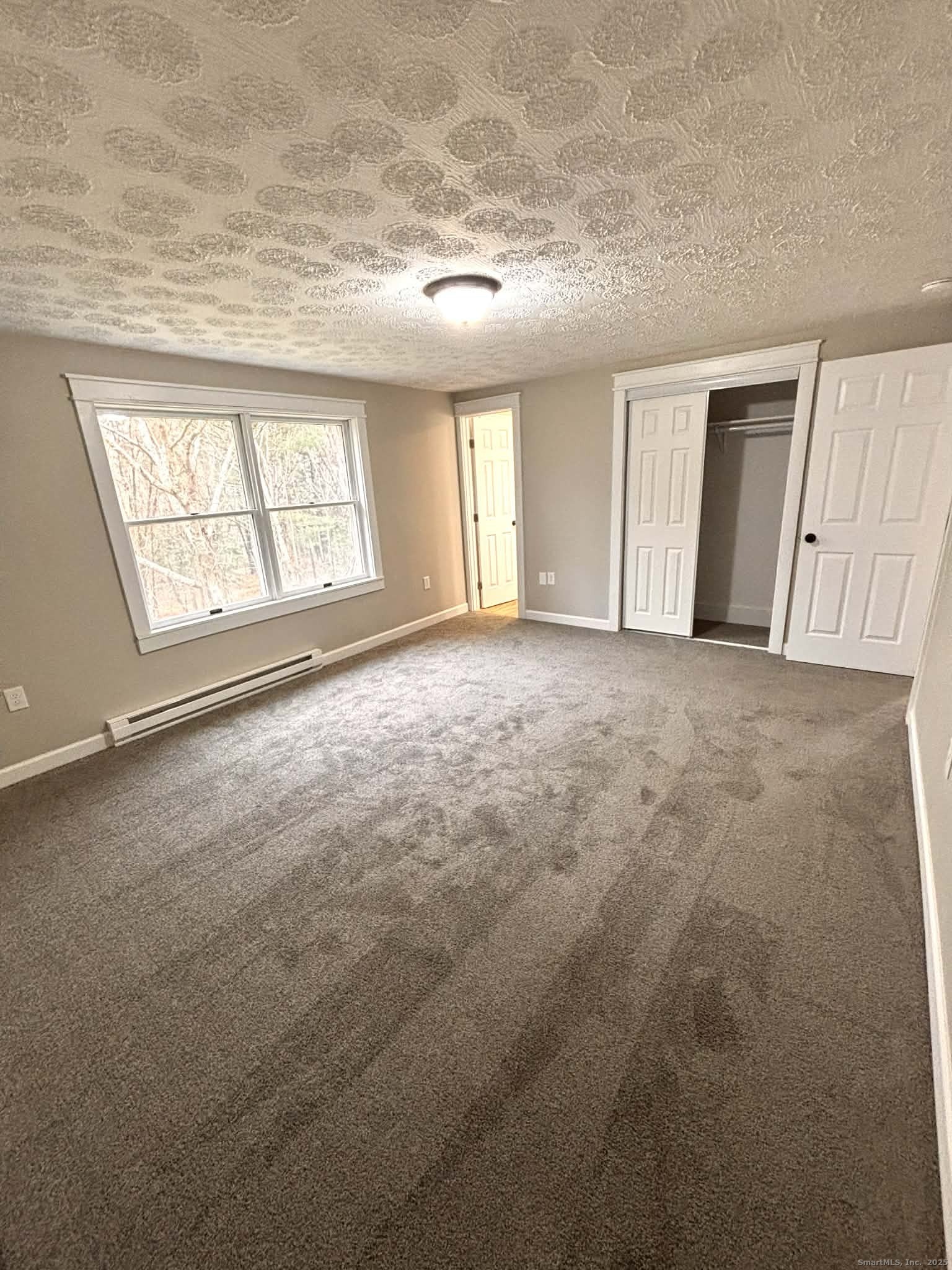 164 Starkweather Road Plainfield, CT 06354 - Photo 11 of 23 an empty room with windows