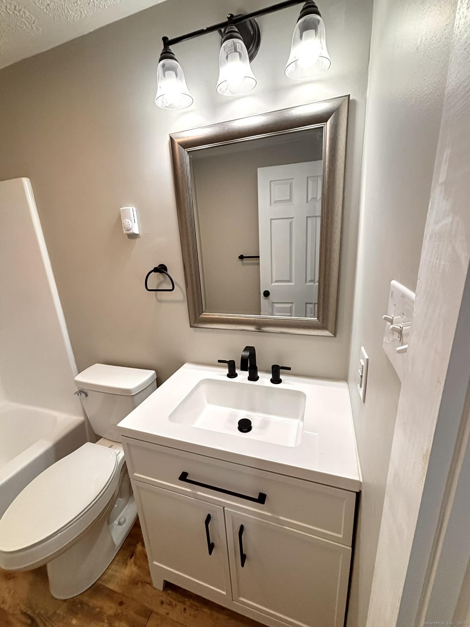 164 Starkweather Road Plainfield, CT 06354 - Photo 12 of 23 a bathroom with a toilet sink and mirror