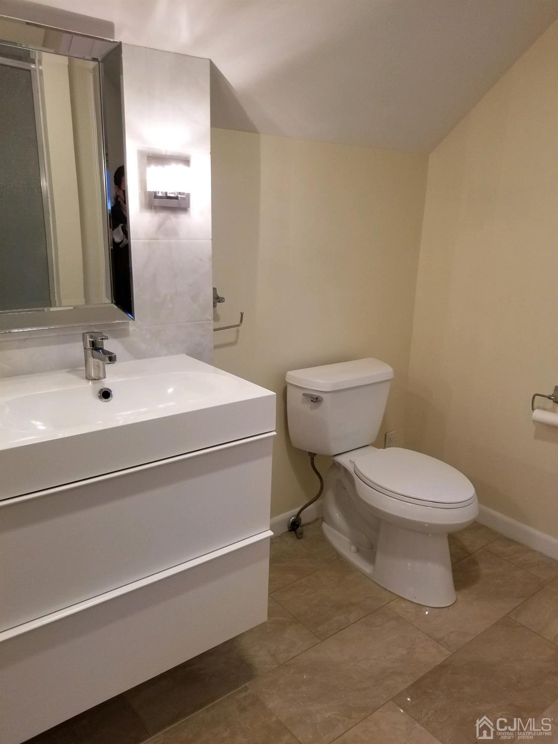 1551 Barton Road Union, NJ 07083 - Photo 4 of 7 a bathroom with a toilet sink and mirror