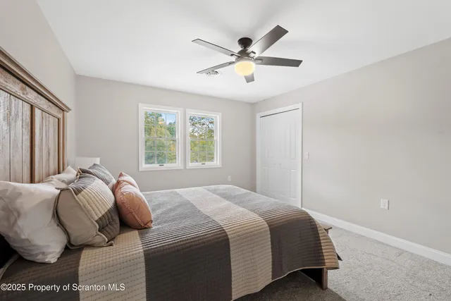 a bathroom with a tub a sink and a window