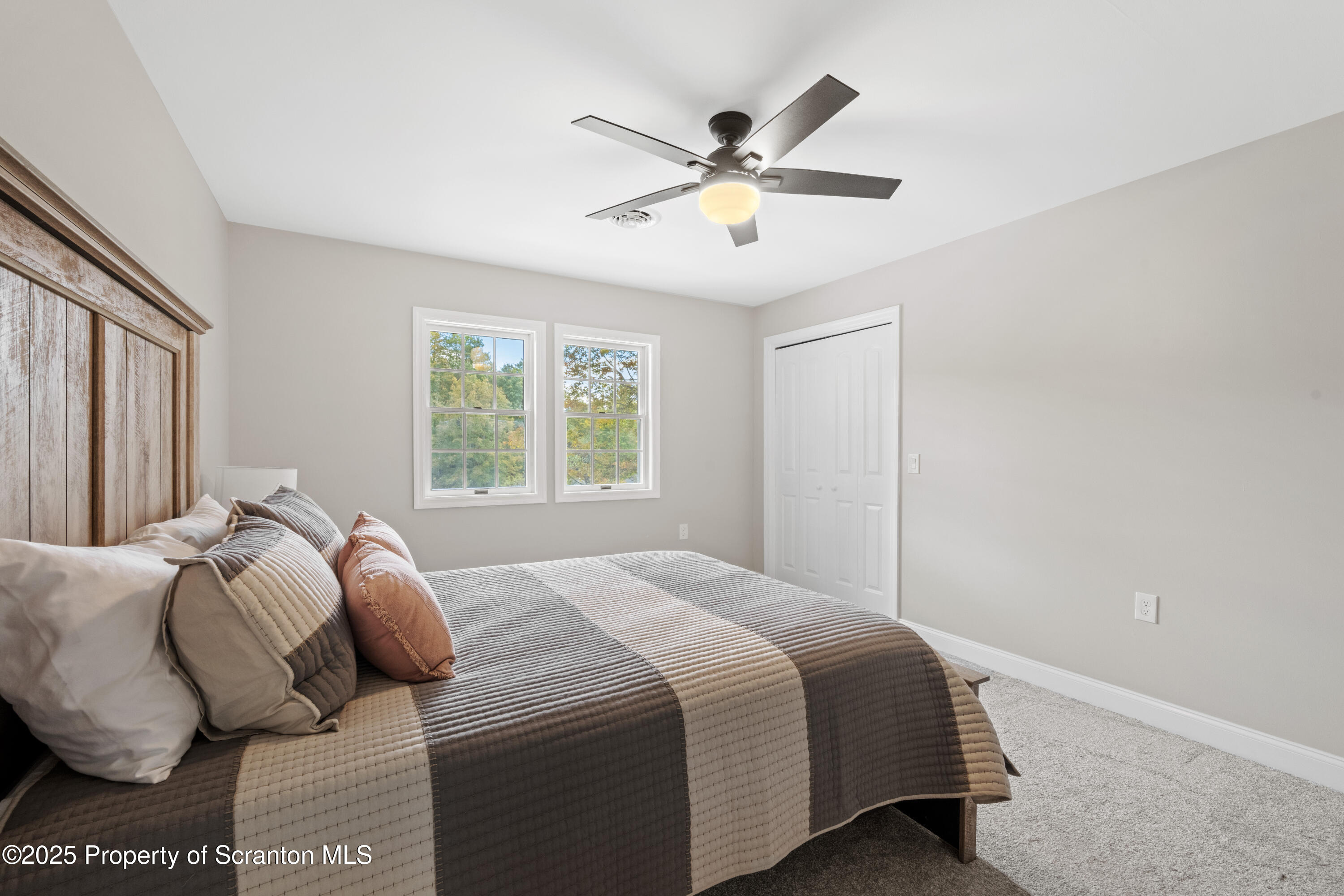 220 Fuller Road Dalton, PA 18414 - Photo 14 of 55 a bedroom with a large bed and a window