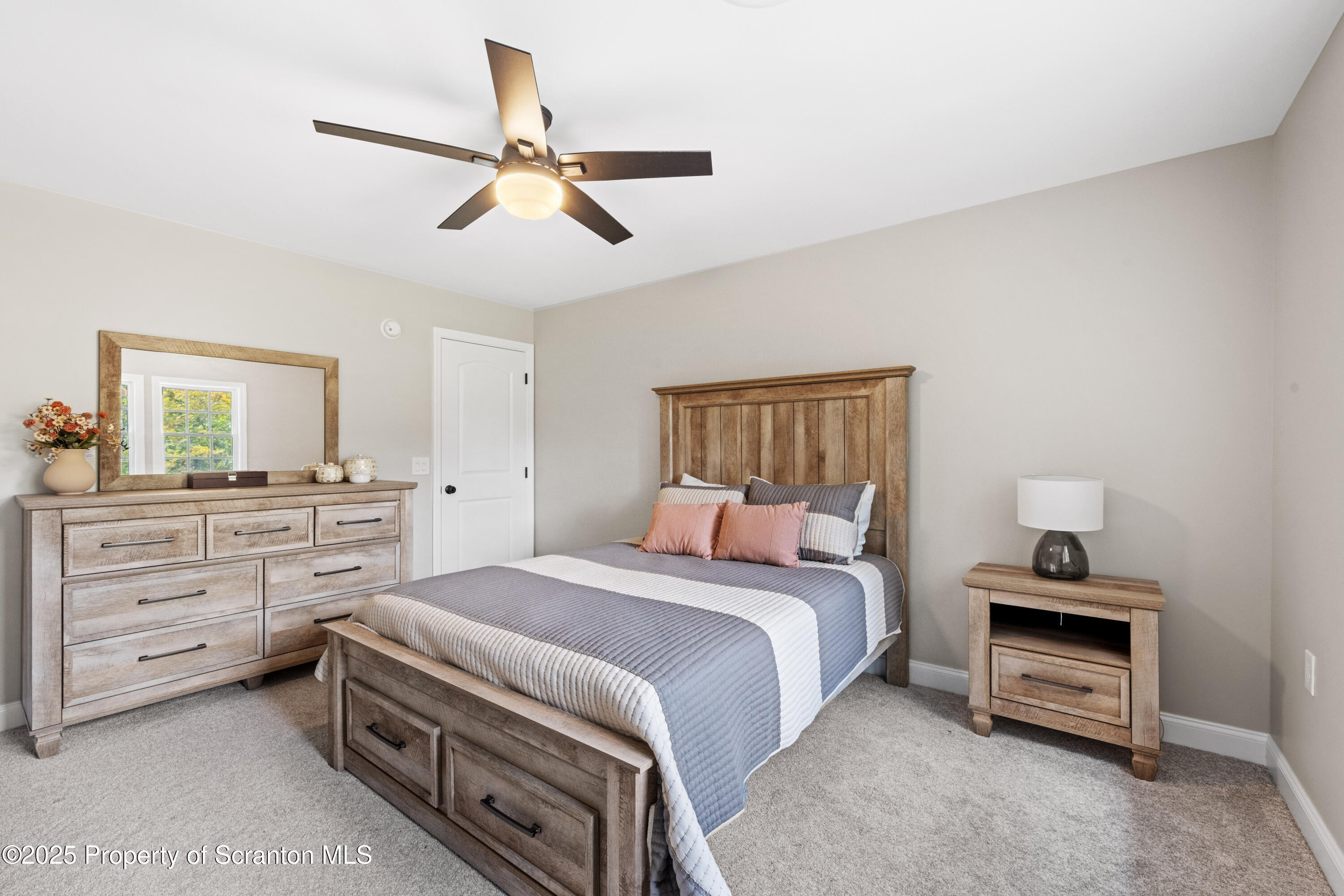 220 Fuller Road Dalton, PA 18414 - Photo 15 of 55 a bedroom with a bed and a chandelier