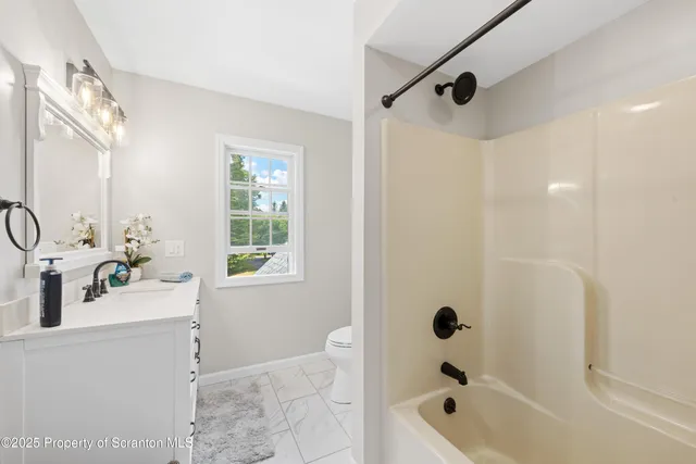 a spacious bedroom with a bed and a large window