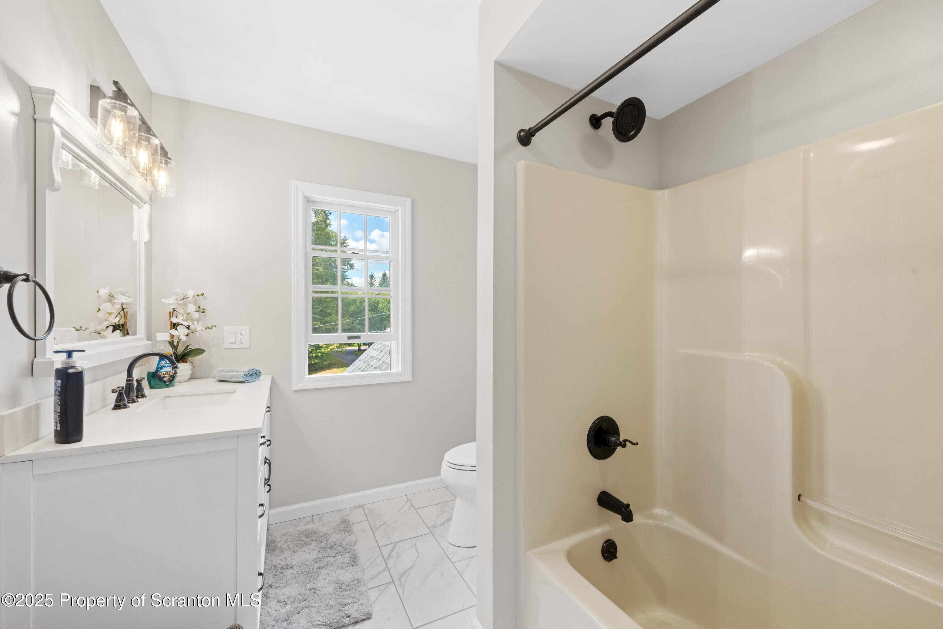 220 Fuller Road Dalton, PA 18414 - Photo 18 of 55 a bathroom with a tub a sink and a window