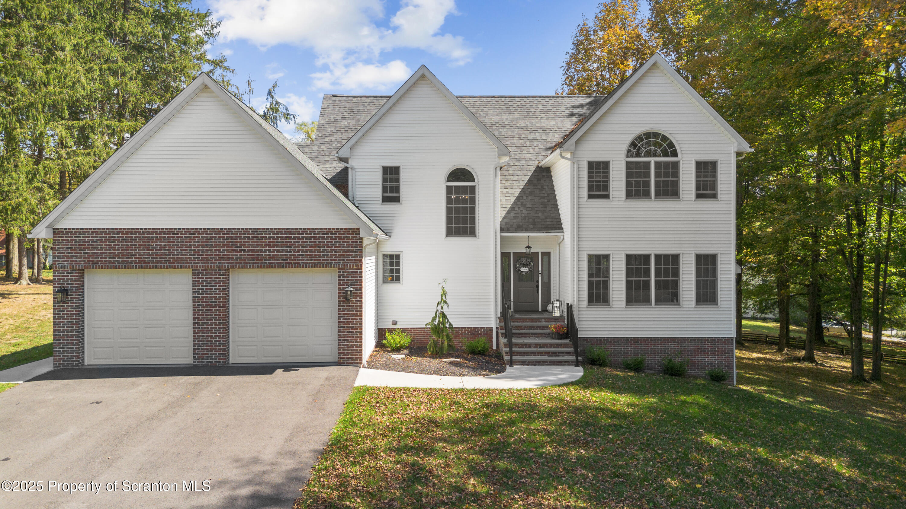 220 Fuller Road Dalton, PA 18414 - Photo 2 of 55 a view of a yard in front of a house with a large tree