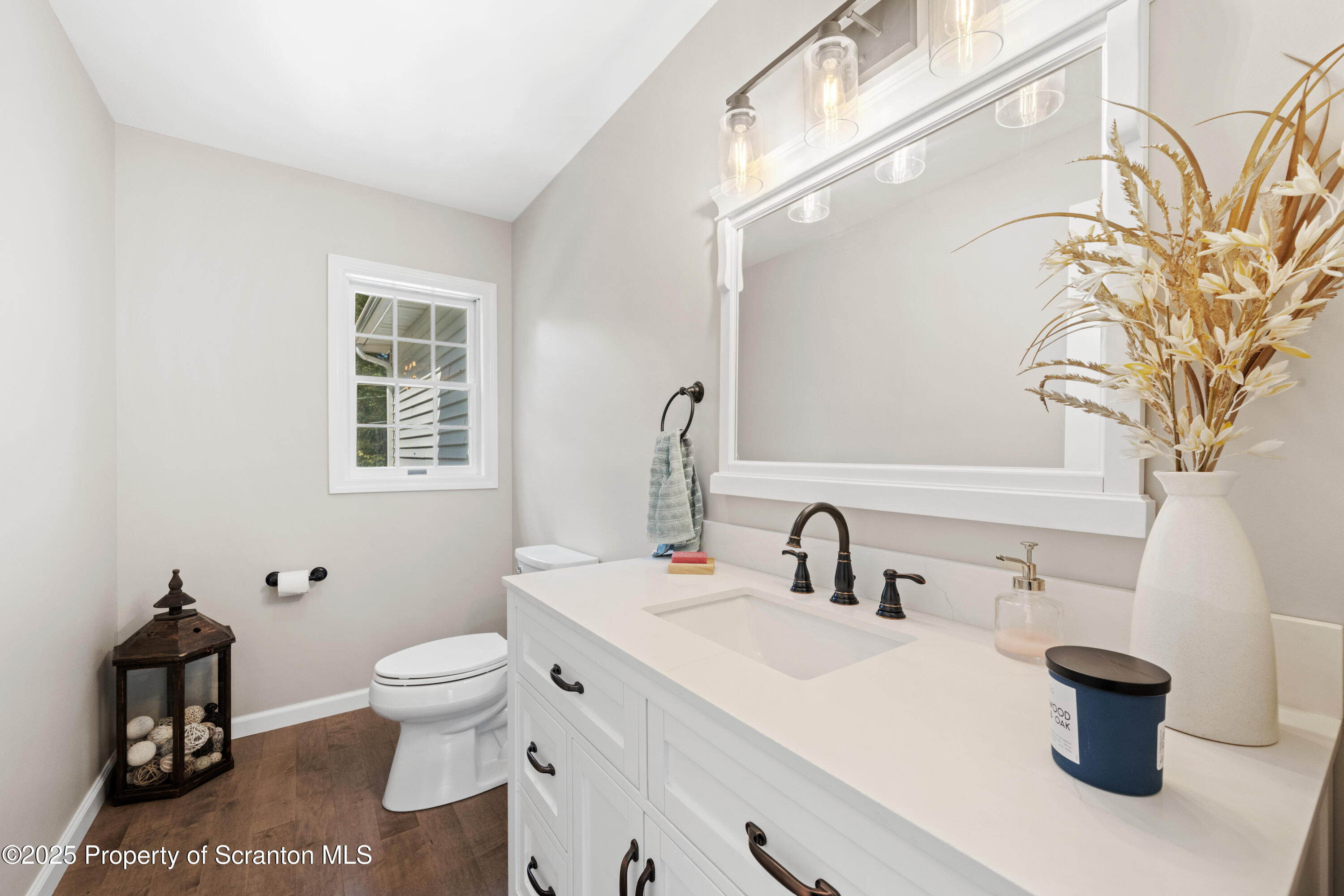 220 Fuller Road Dalton, PA 18414 - Photo 28 of 55 a bathroom with a toilet sink and mirror