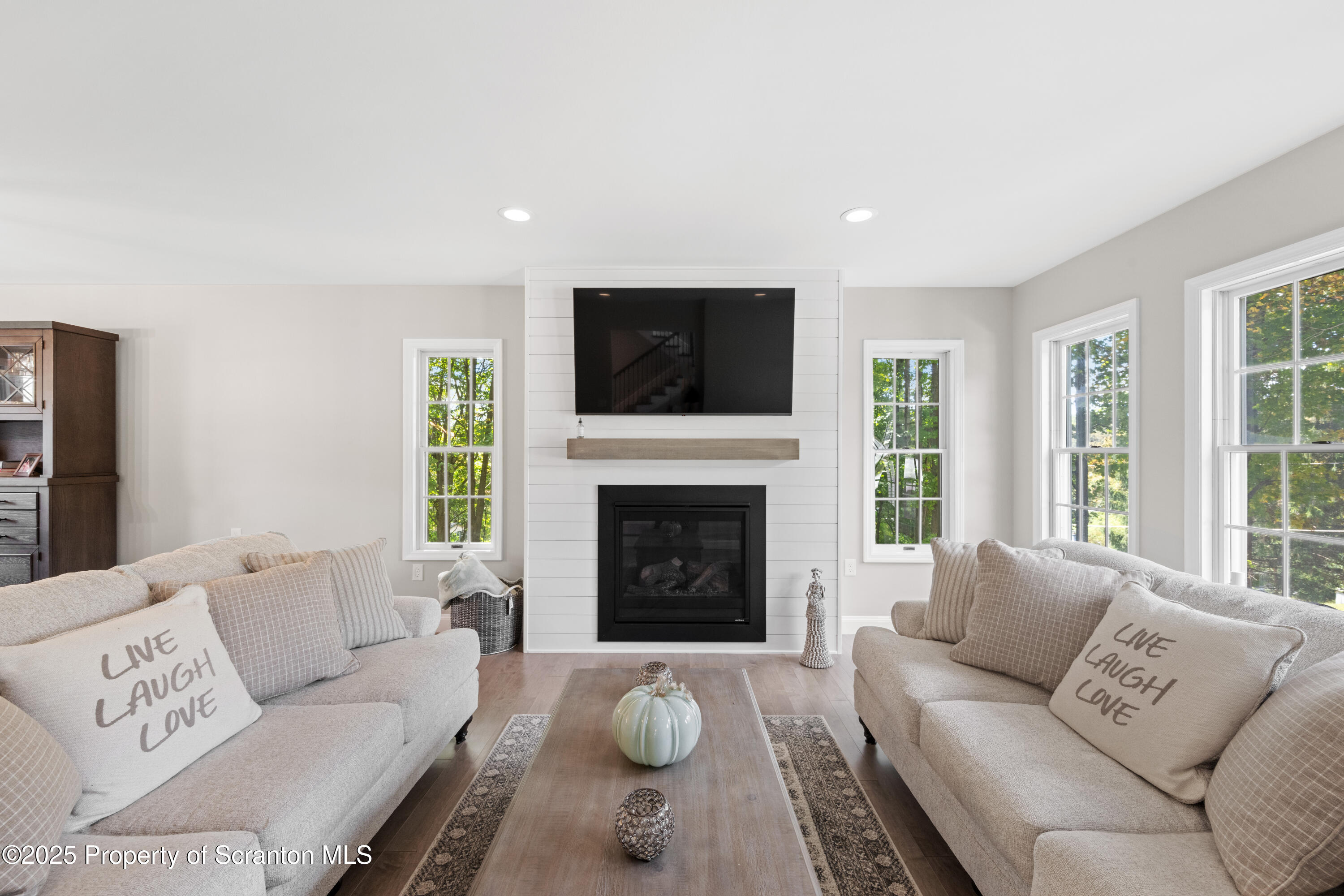220 Fuller Road Dalton, PA 18414 - Photo 44 of 55 a living room with furniture a fireplace and a flat screen tv