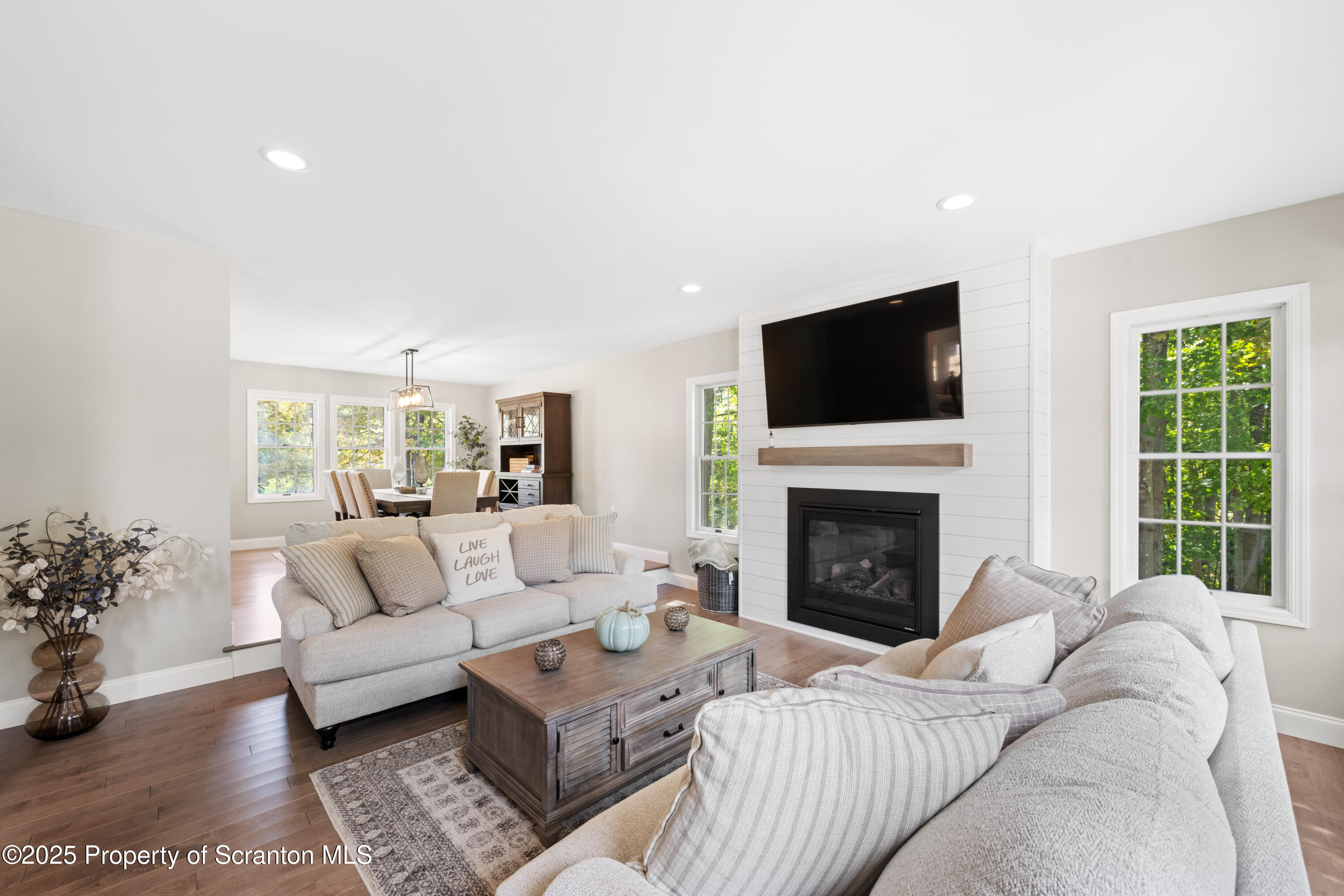 220 Fuller Road Dalton, PA 18414 - Photo 45 of 55 a living room with furniture a fireplace and a flat screen tv