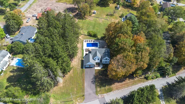 a view of a house with backyard sitting area and garden