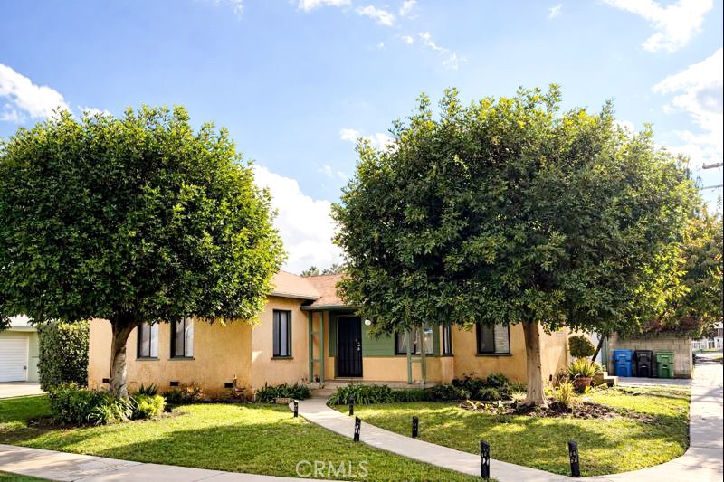a front view of a house with garden