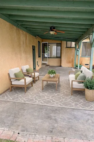 a living room with furniture and a potted plant