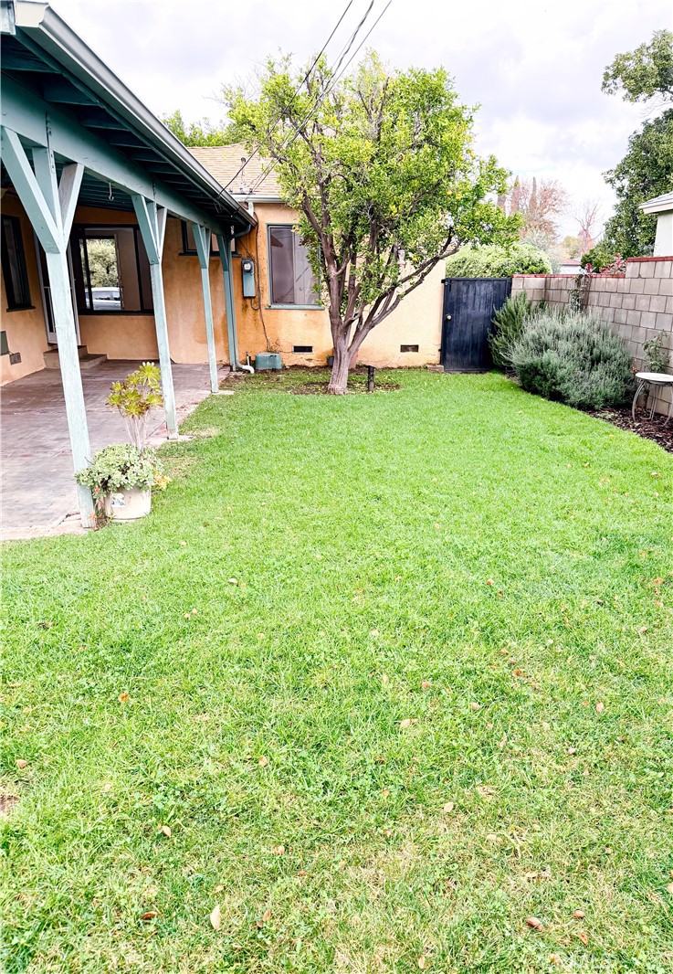 18424 Calvert Street Tarzana, CA 91335 - Photo 20 of 25 a front view of a house with a yard and garage