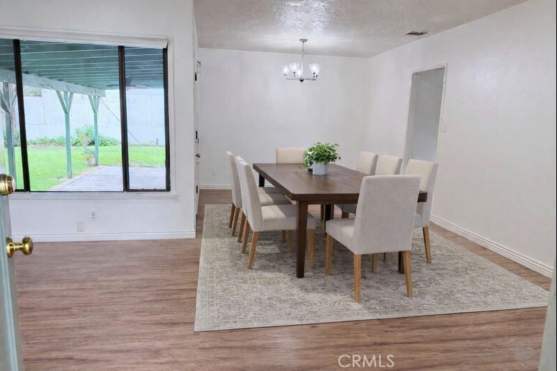 18424 Calvert Street Tarzana, CA 91335 - Photo 2 of 25 a view of a dining room with furniture and a floor to ceiling window