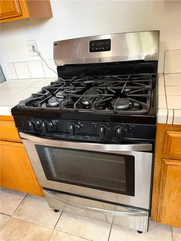 a stove top oven sitting inside of a kitchen