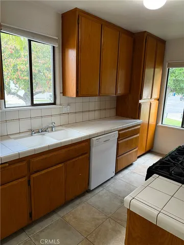 a kitchen with a sink cabinets and window