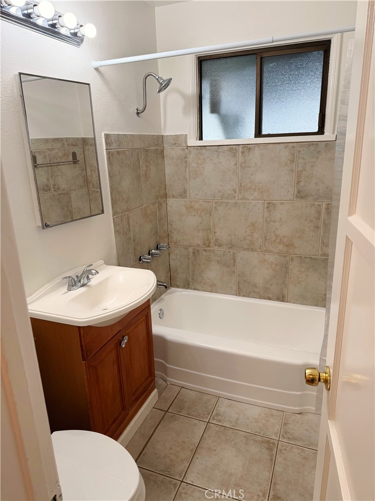 18424 Calvert Street Tarzana, CA 91335 - Photo 8 of 25 a bathroom with a sink a toilet and a bathtub