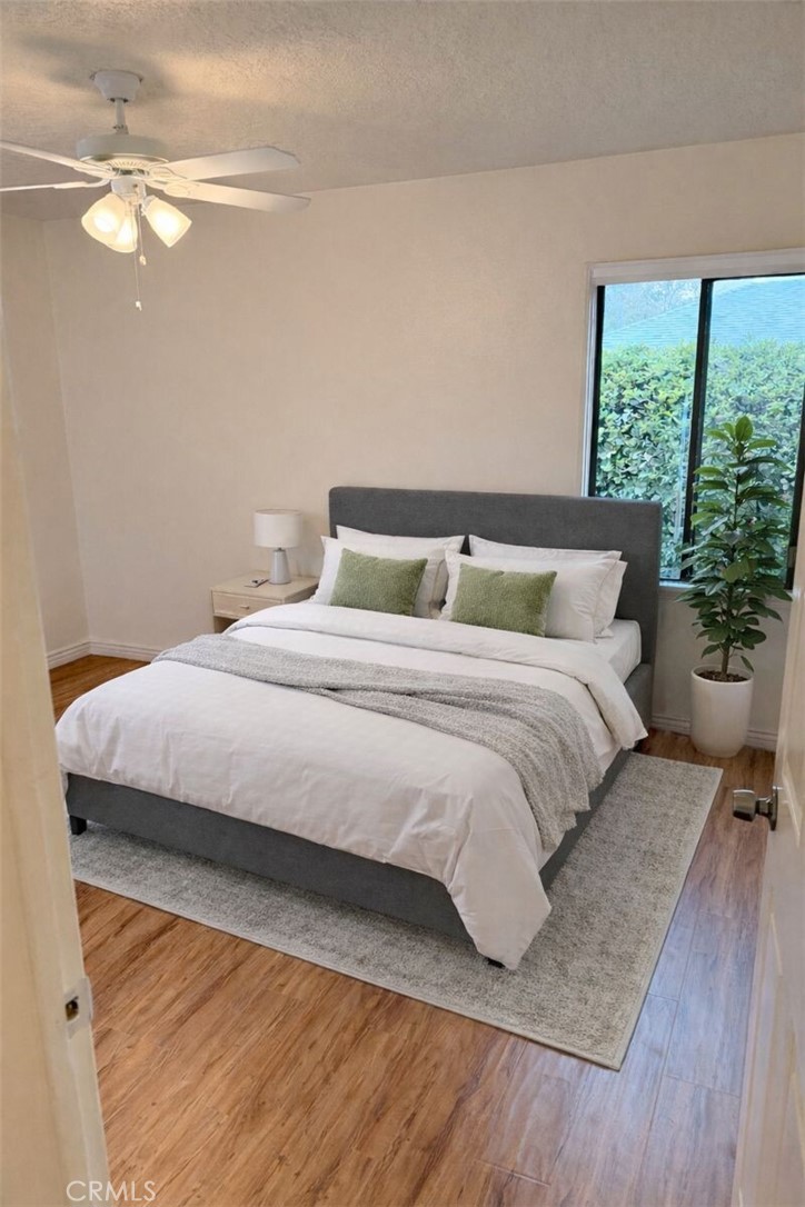 18424 Calvert Street Tarzana, CA 91335 - Photo 10 of 25 a bedroom with a large bed and a chandelier