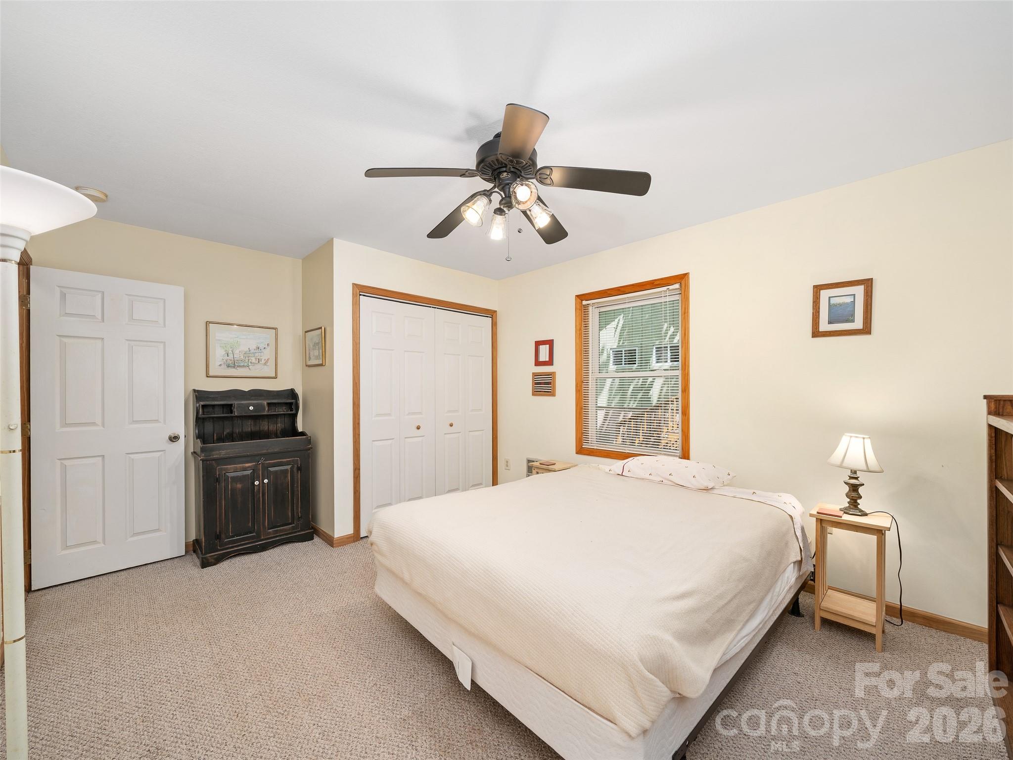 142 Wildflower Road Spruce Pine, NC 28777 - Photo 21 of 46 a bedroom with a large bed and a chandelier