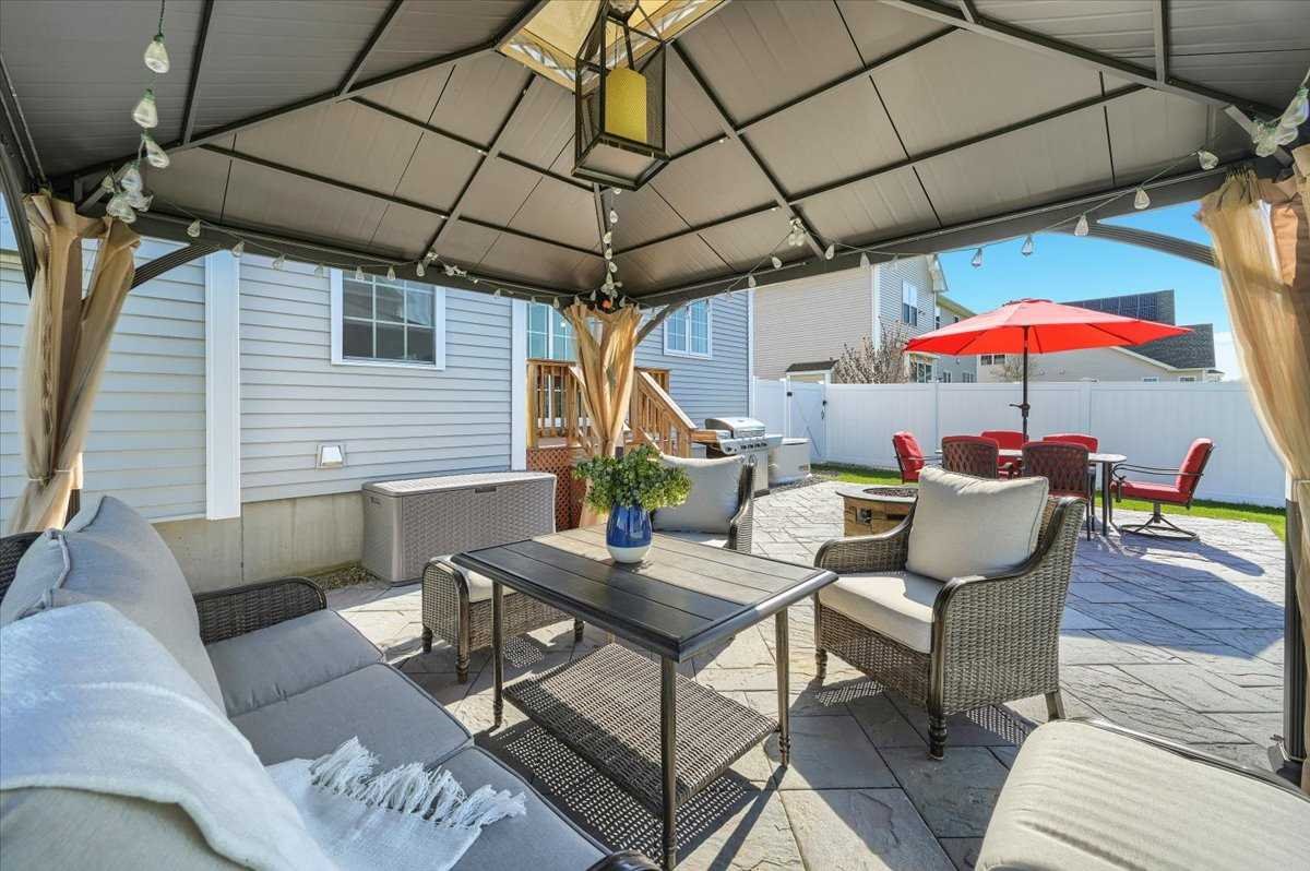 41 Pitcher Road East Fishkill, NY 12533 - Photo 30 of 35 a patio with a table and chairs under an umbrella