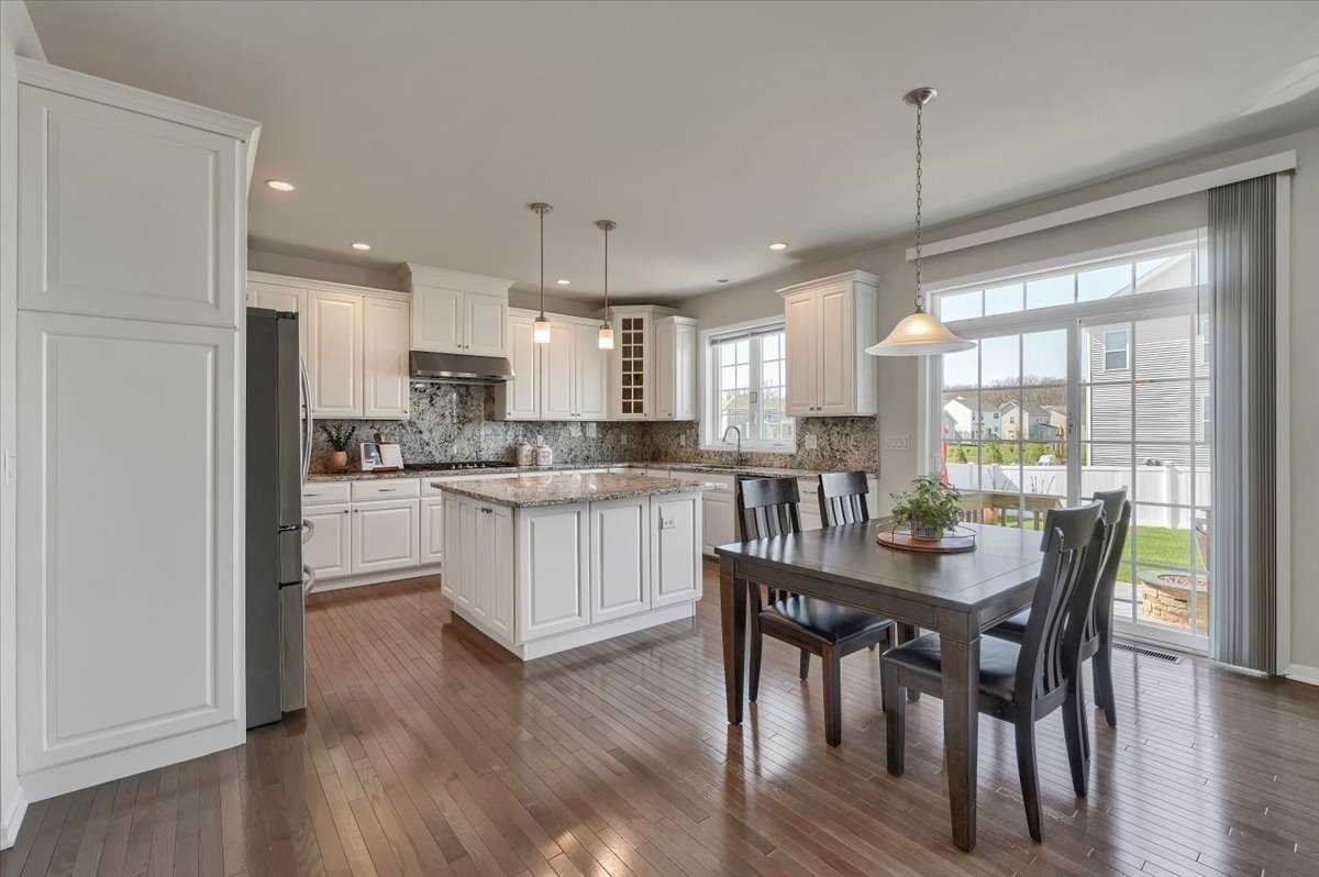 41 Pitcher Road East Fishkill, NY 12533 - Photo 8 of 35 a kitchen with a dining table chairs stainless steel appliances and cabinets