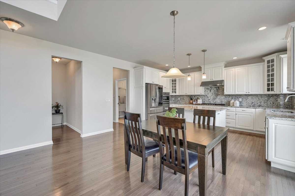 41 Pitcher Road East Fishkill, NY 12533 - Photo 9 of 35 a kitchen with kitchen island a dining table chairs and white cabinets