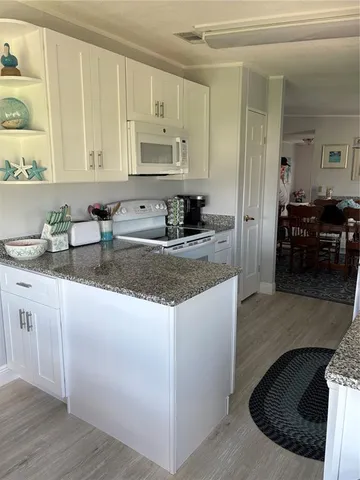 a kitchen with sink a stove and cabinets