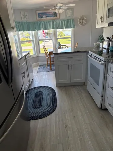 a kitchen with stainless steel appliances a stove a microwave a sink and a refrigerator