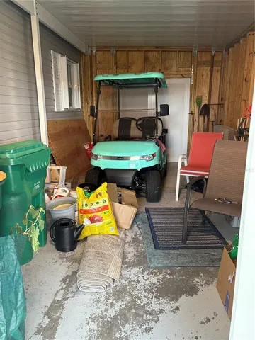 a view of a chair and table in backyard of the house