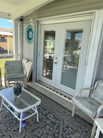 a room with pool table and windows