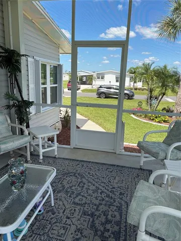 a living room with a floor to ceiling window and a table
