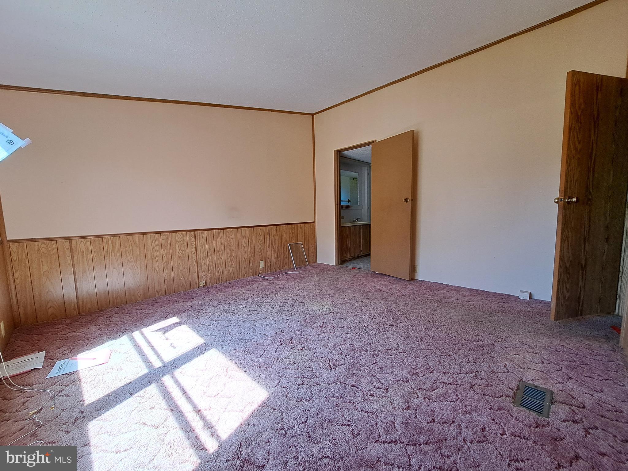 6706 Whiteley Road Hurlock, MD 21643 - Photo 15 of 45 a view of an empty room with wooden floor and a window