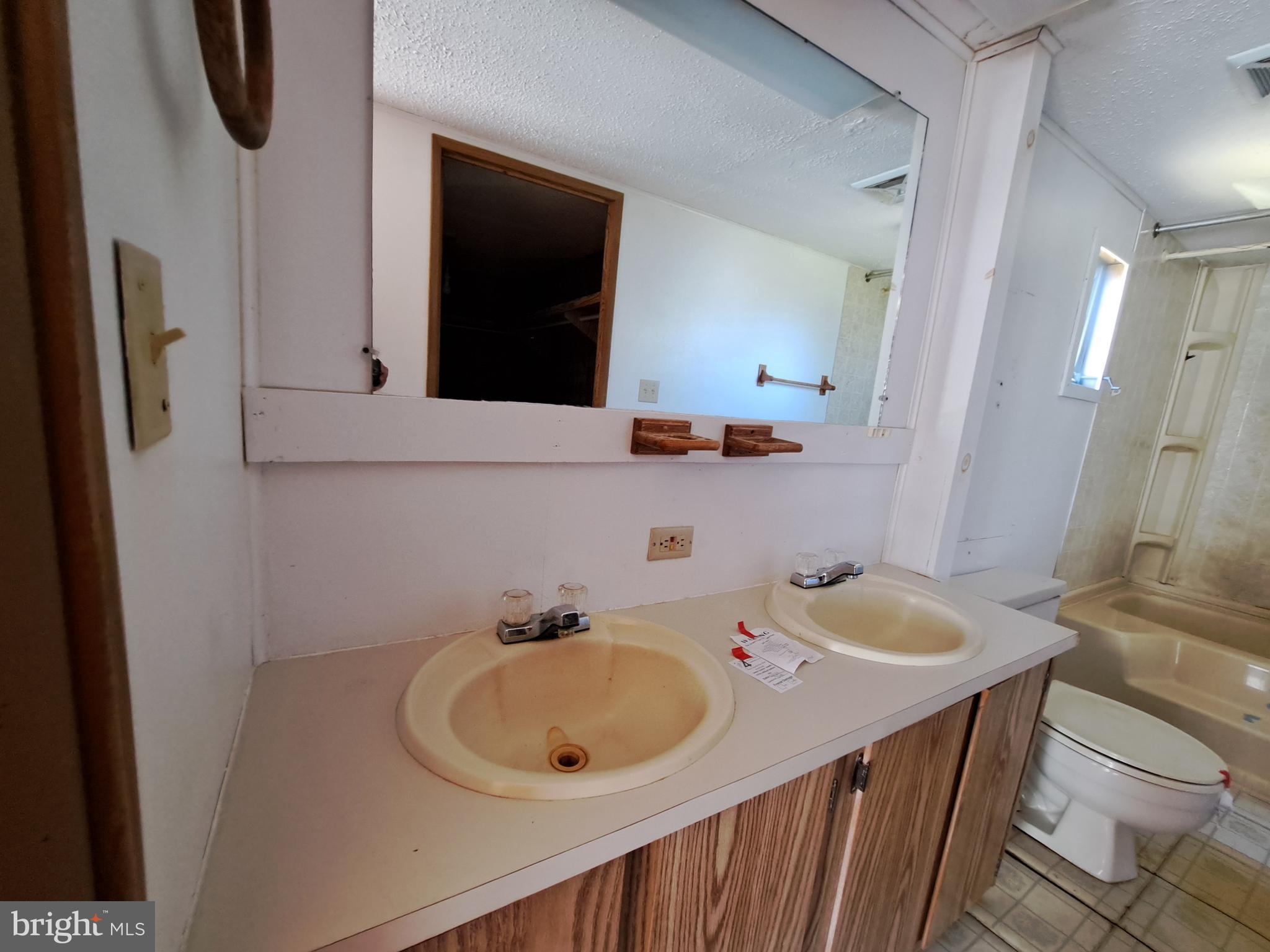 6706 Whiteley Road Hurlock, MD 21643 - Photo 18 of 45 a bathroom with a sink and mirror