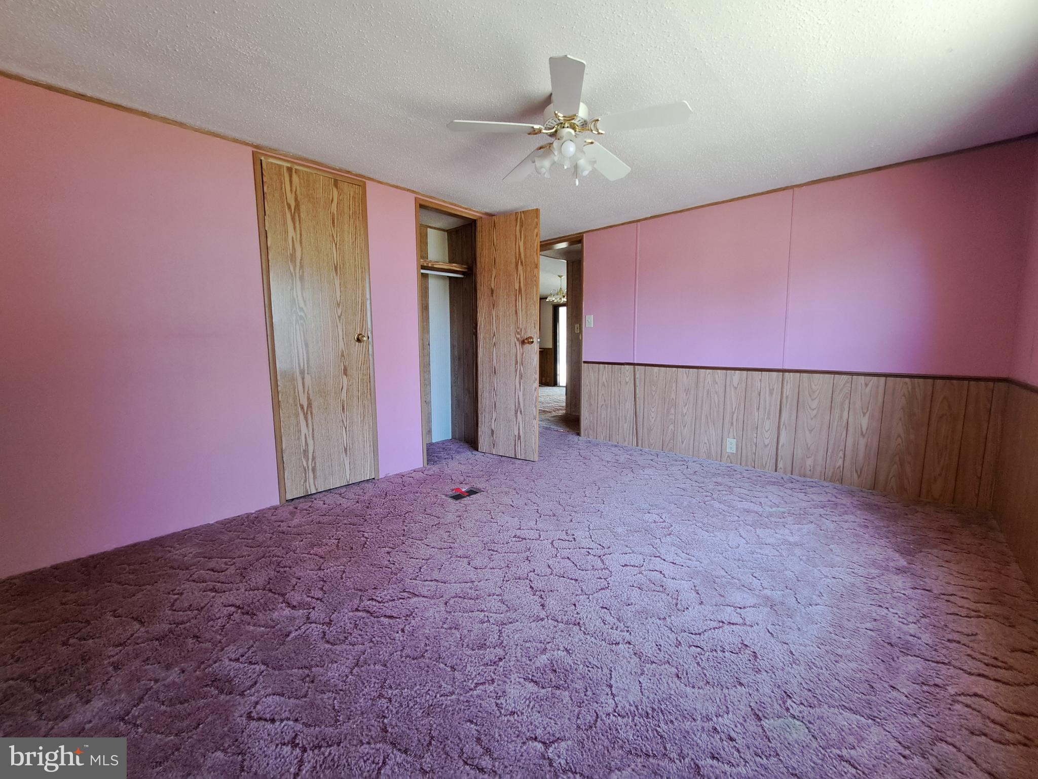 6706 Whiteley Road Hurlock, MD 21643 - Photo 22 of 45 a view of livingroom with hallway and a chandelier fan