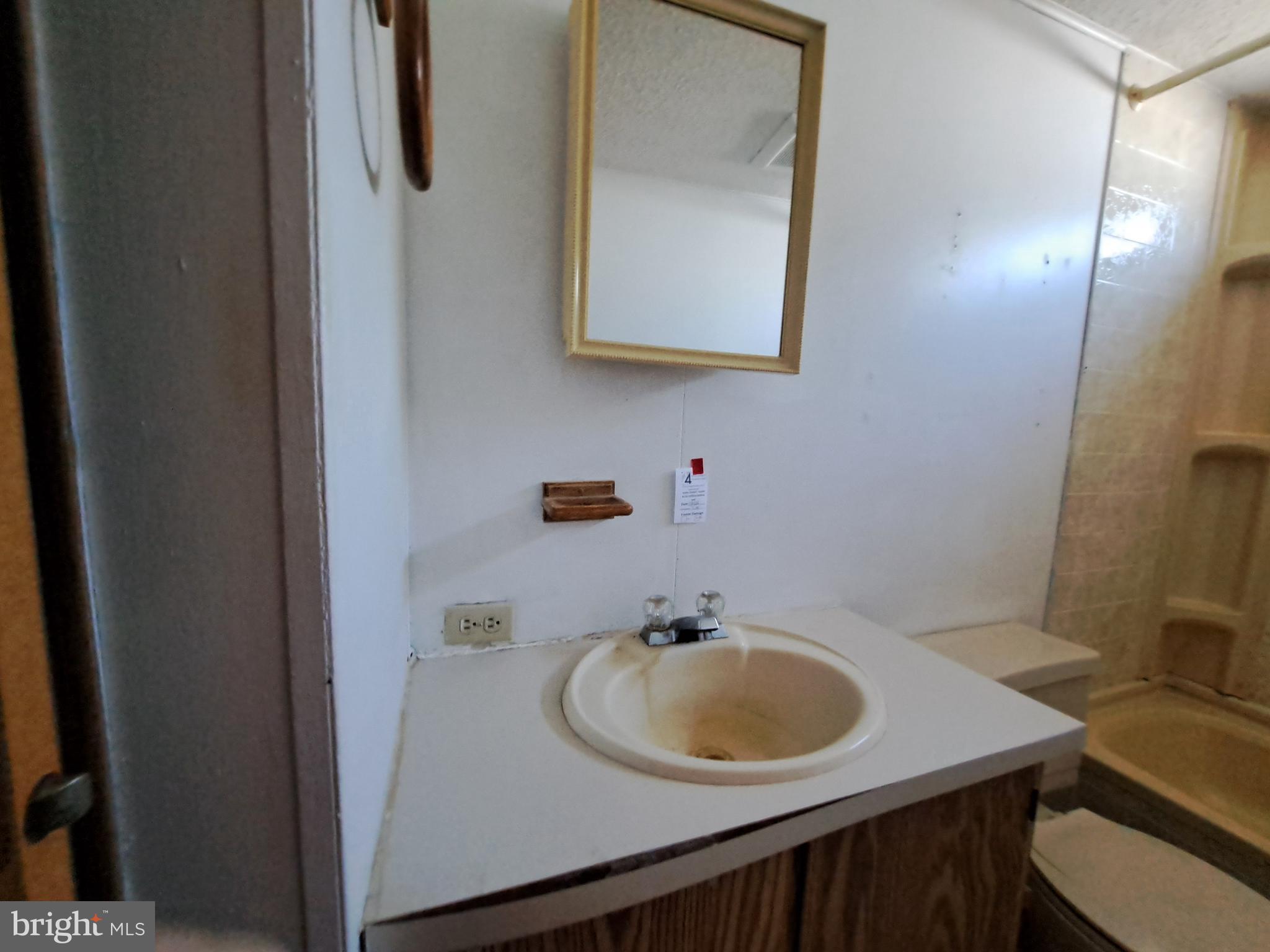 6706 Whiteley Road Hurlock, MD 21643 - Photo 26 of 45 a bathroom with a sink and a mirror